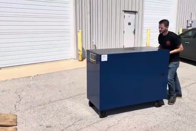 Easing a heavy safe out on the dolly