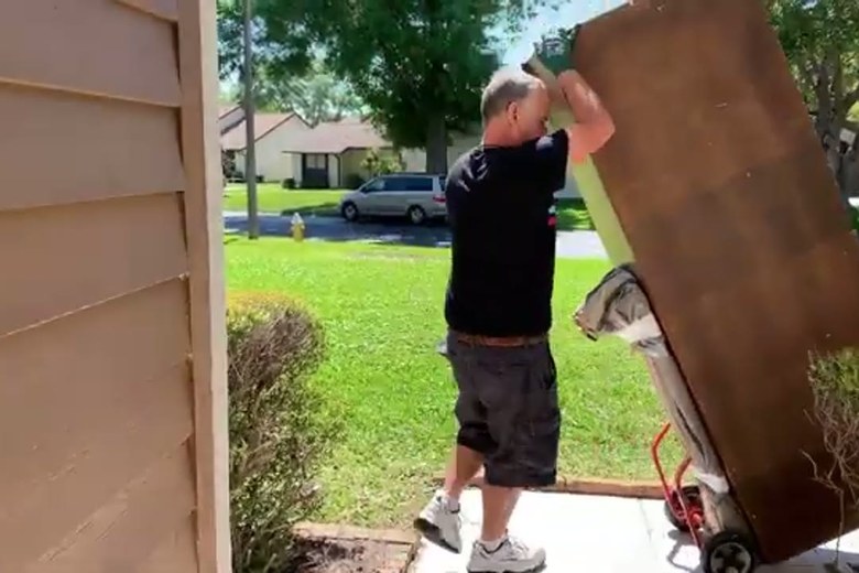 Wheeling a solid-wood wardrobe out the door